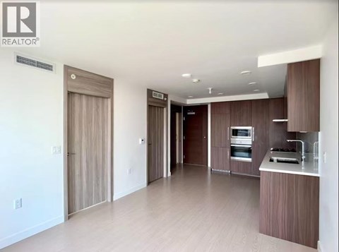 A modern kitchen with wooden cabinets and appliances.