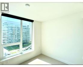 A realtor logo is on a window in a white room.