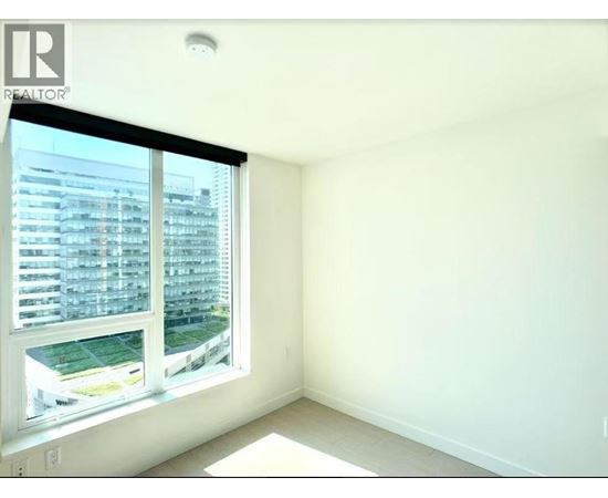 A realtor logo is on a window in a white room.