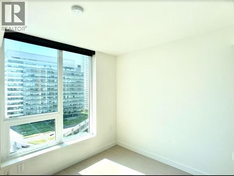 A realtor logo is on a window in a white room.