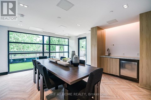 A modern dining room with a wooden table and chairs.