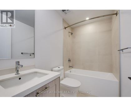 A white bathroom with a sink, toilet, and bathtub.