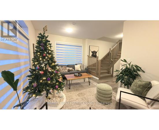 A living room with a Christmas tree and a staircase.