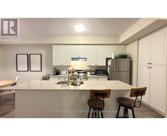 A modern kitchen with white cabinets and a central island.