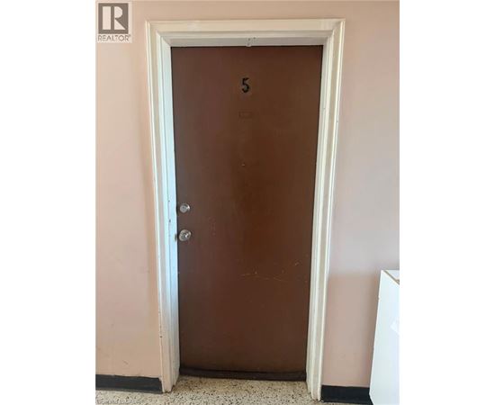 A brown door with a number 5 on it.