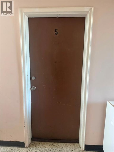 A brown door with a number 5 on it.