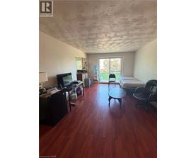 A room with a wooden floor and a ceiling with a textured finish.