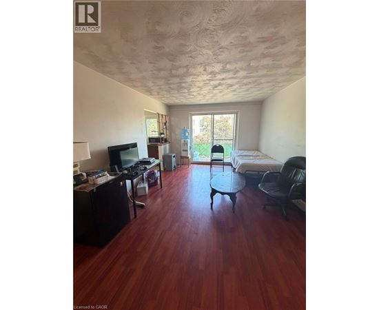 A room with a wooden floor and a ceiling with a textured finish.