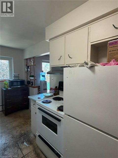 A kitchen with a white refrigerator and a white oven.
