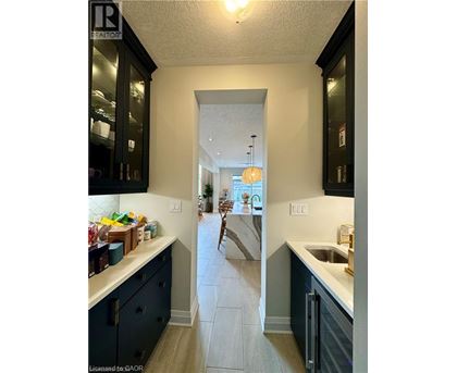 A kitchen with a sink and a refrigerator.