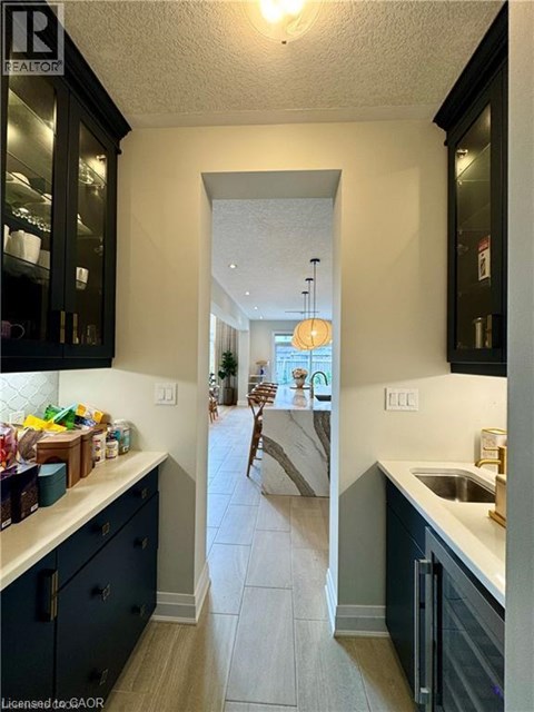 A kitchen with a sink and a refrigerator.