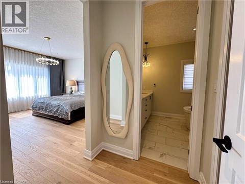 A bedroom with a large mirror and a bed.