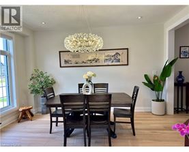 A dining room with a wooden table and chairs.