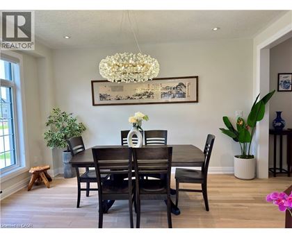 A dining room with a wooden table and chairs.