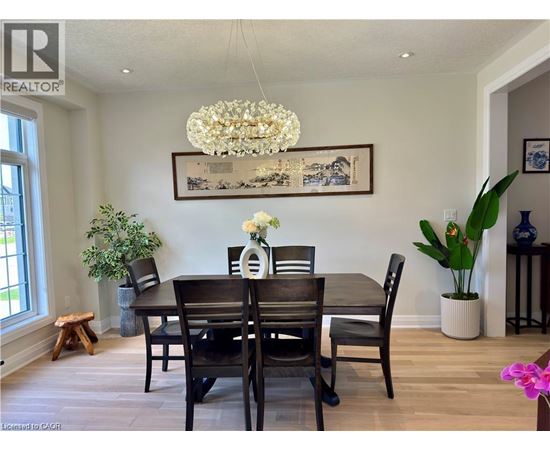 A dining room with a wooden table and chairs.