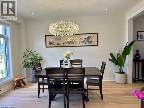 A dining room with a wooden table and chairs.