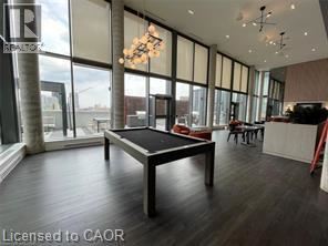 A modern living room with a black sofa and a white coffee table.
