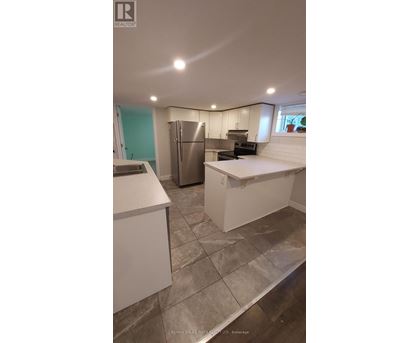 A kitchen with a refrigerator, stove, and oven.