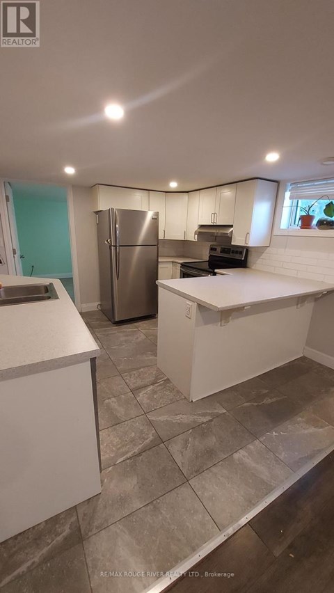 A kitchen with a refrigerator, stove, and oven.