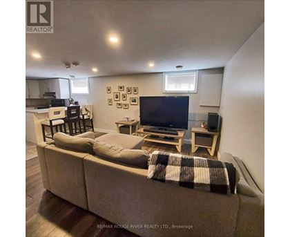 A living room with a couch, a television, and a coffee table.