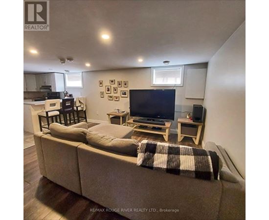 A living room with a couch, a television, and a coffee table.