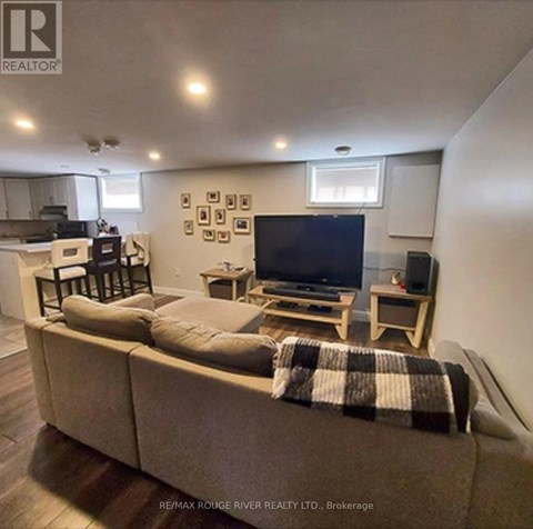 A living room with a couch, a television, and a coffee table.