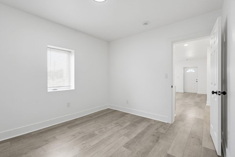 A room with a wooden floor and white walls.