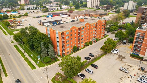 A large orange building sits in the middle of a parking lot.