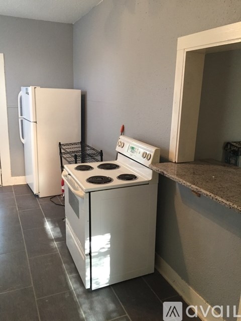 A white stove and refrigerator in a kitchen.