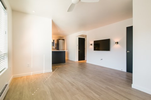 A room with a wooden floor and a ceiling fan.