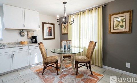 A dining room with a glass table and chairs.