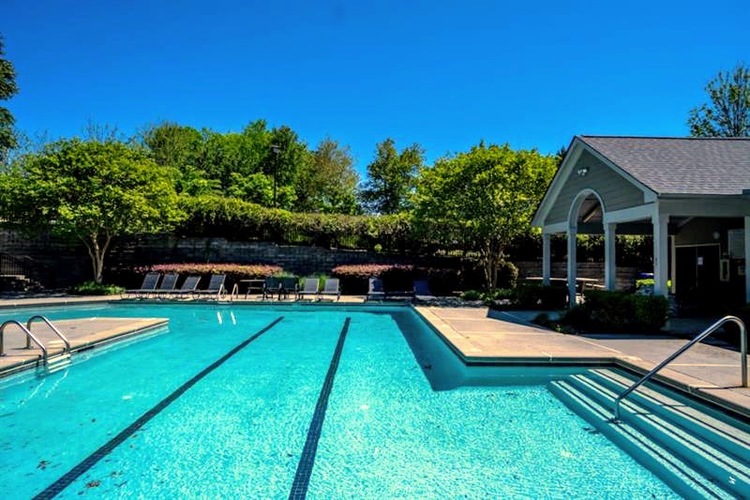 A large swimming pool with a building in the background.