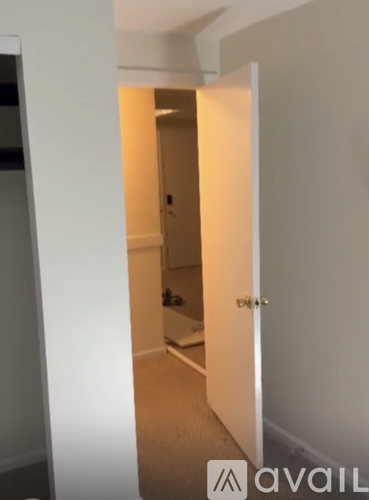 A white door is open to a hallway.