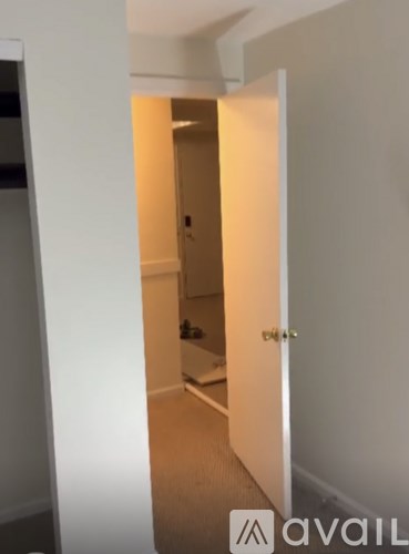 A white door is open to a hallway.