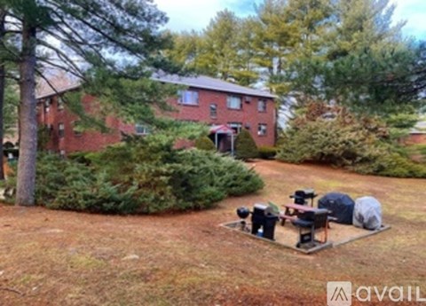 A backyard with a picnic table and chairs.