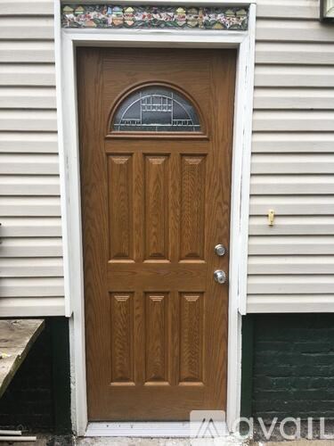 A brown door with a glass window above the handle.