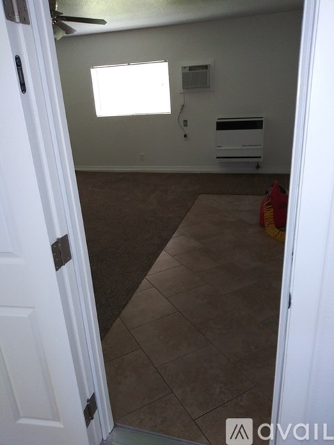 A room with a tiled floor and a window.
