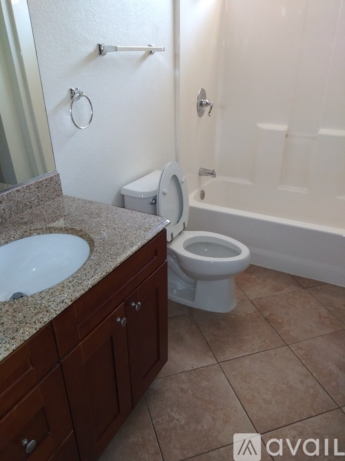 A bathroom with a toilet, sink, and bathtub.