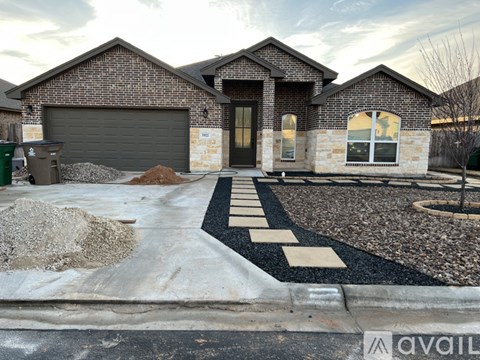 A house with a driveway in front of it.