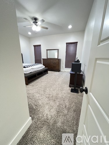 A bedroom with a bed, dresser, and mirror.