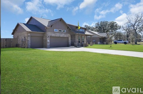 A house with a garage and a car parked in front.