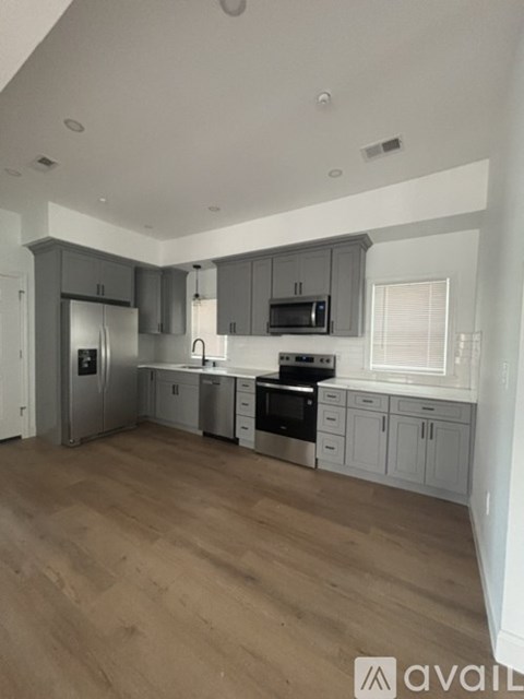 A kitchen with wooden floors and modern appliances.