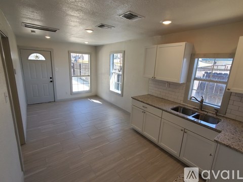 A kitchen with a sink and cabinets.