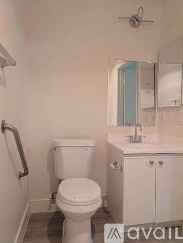 A white toilet and sink in a bathroom.