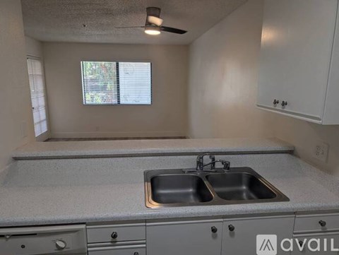 A kitchen with a sink and a window.