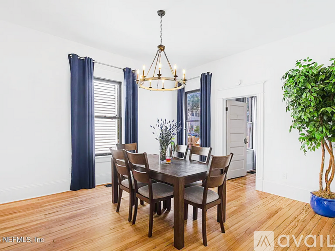 A dining room with a wooden table and chairs.