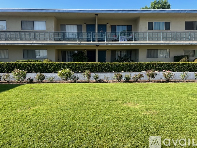 A building with a green lawn in front of it.