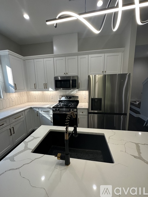 A kitchen with a sink and a stove.