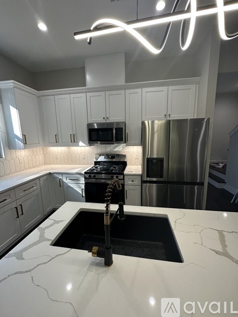 A kitchen with a sink and a stove.