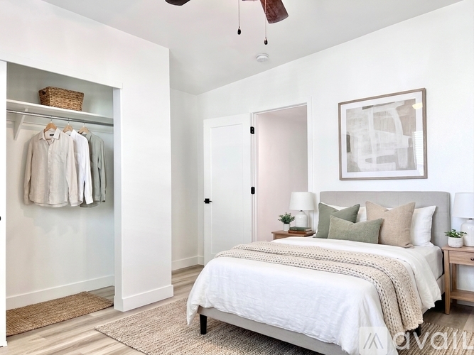 A bedroom with a bed, nightstands, and a closet.